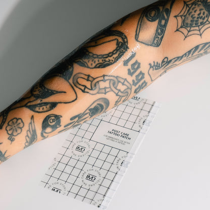 IMD Post Care Tattoo Patch applied to a tattooed forearm — dermatologist-approved waterproof wrap for new ink healing