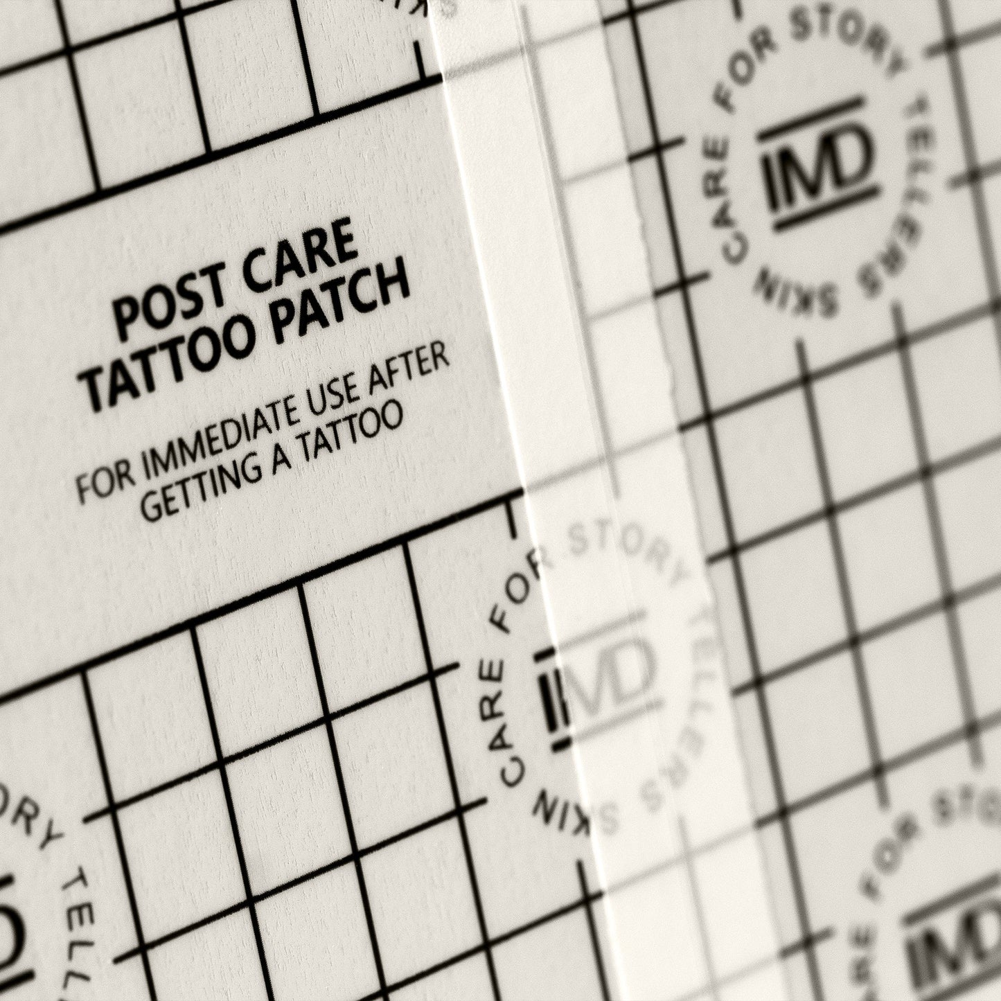 Close-up of IMD Post Care Tattoo Patch — waterproof, breathable film with grid texture for new tattoo aftercare